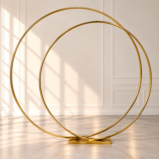 Double gold ring wedding arch with two overlapping circular gold metal frames for elegant wedding and event backdrop rentals in Ottawa.