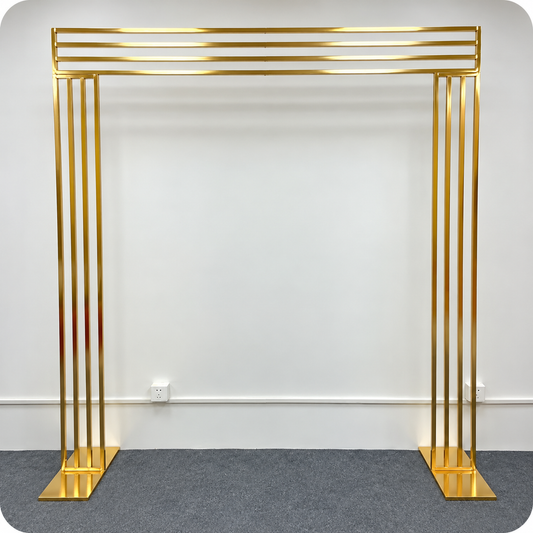 Large gold metal wedding arch backdrop with rectangular frame, vertical side bars and detachable bases for event rentals in Ottawa